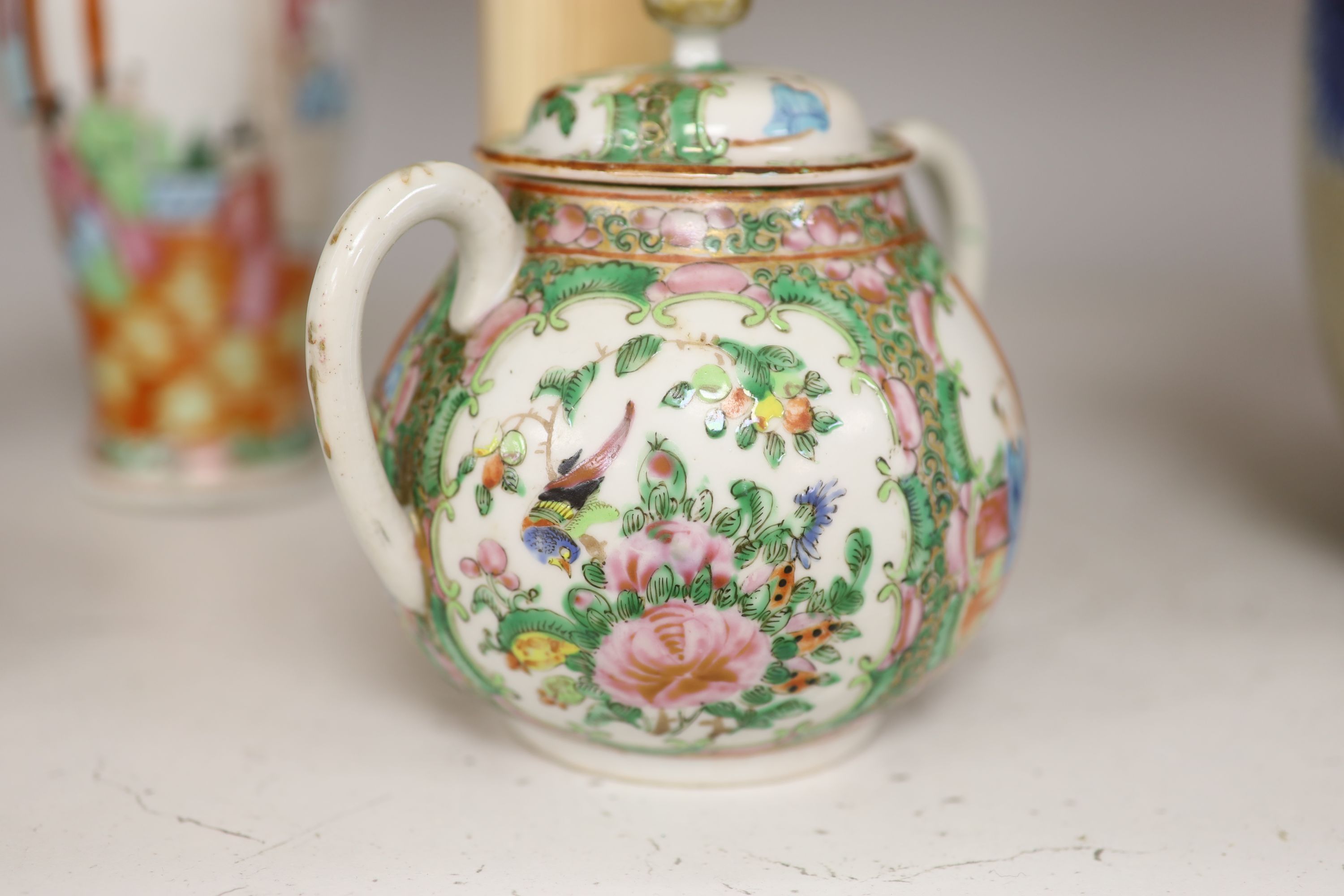 A Chinese famille rose box and cover, two vases, a sugar bowl and cover and a saucer, late 19th/early 20th century, tallest 19cm